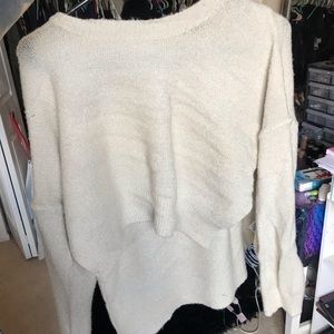 Simple white sweater with tail backing.